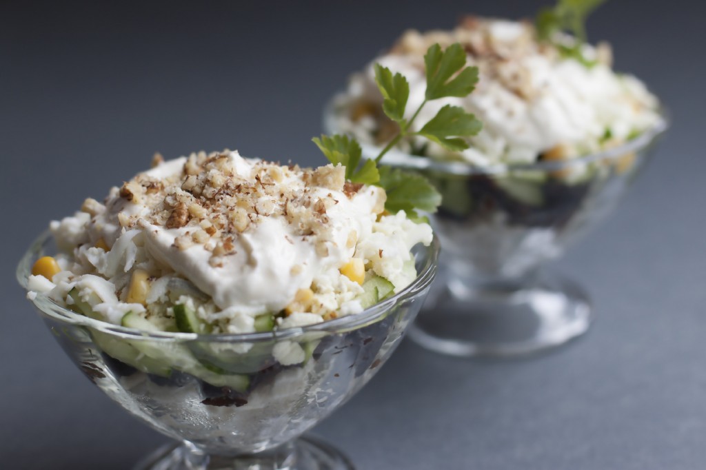 Salad with chicken meat, prunes, cucumbers, boiled egg, walnuts with a sauce of sour cream and mayonnaise.