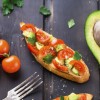 Bruschetta with tomato, avocado and herbs